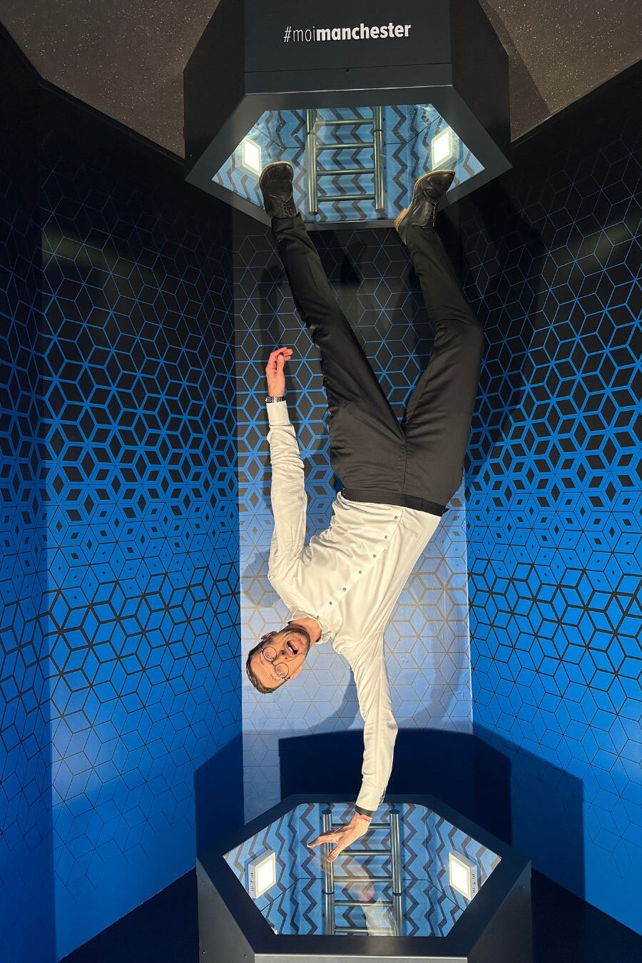 Close-Up Chris in an upside-down room illusion at the Museum of Illusions Manchester